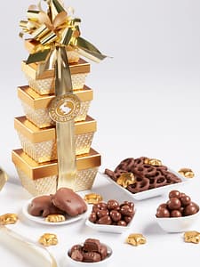 5 gold box tower filled with gourmet milk chocolates with gold bow. chocolate ballotin tower.