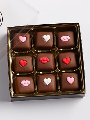 9 caramels with heart icing decals in a box