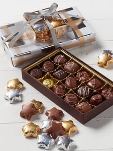 1/2 lb. assorted chocolate set wrapped in festive paper and topped with gold and silver foil chocolate stars.