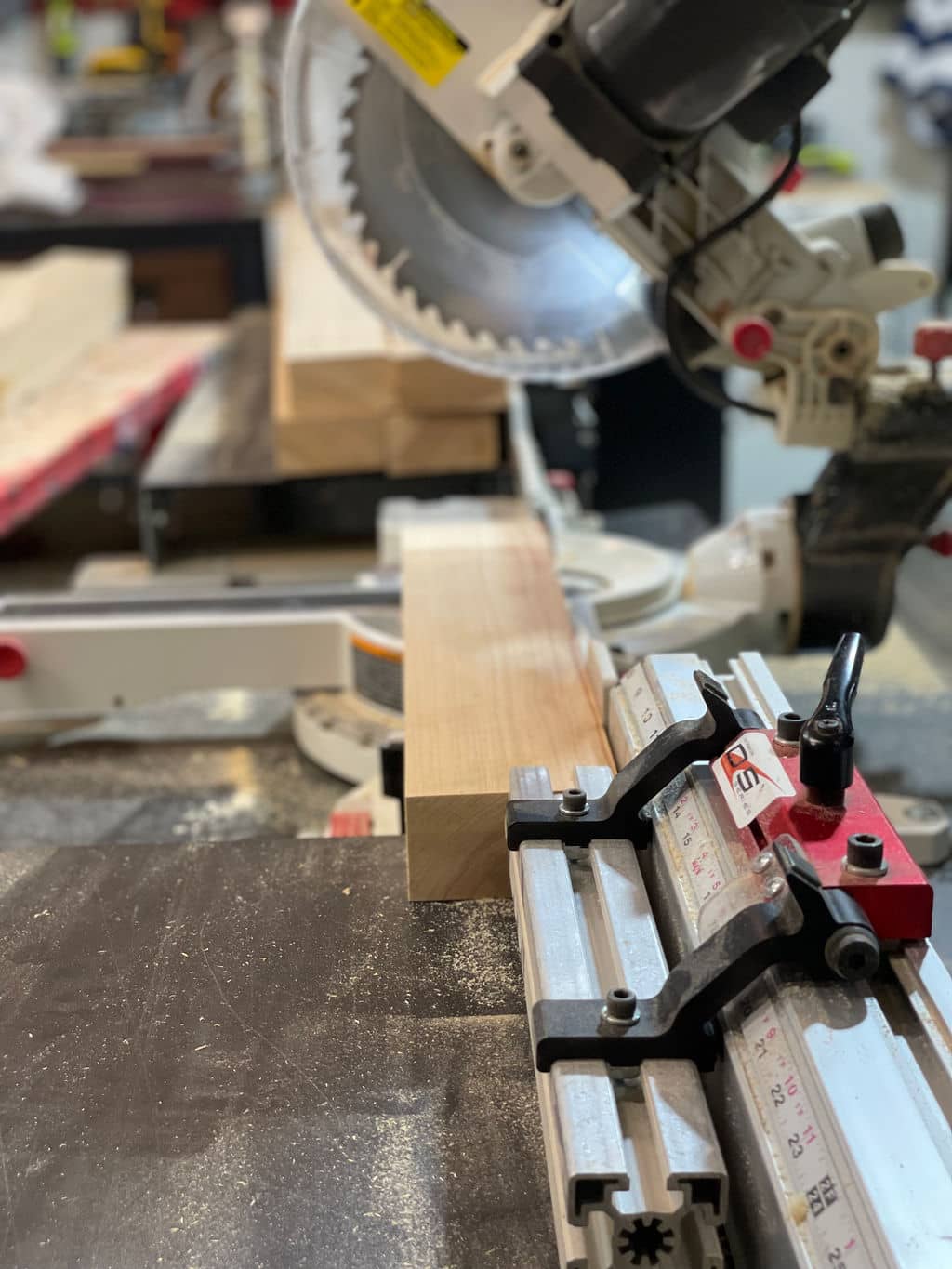 Meaure accurately with the hlpe of a Wood Cutting Station. Miter saw is cutting wood while being measured with a Saw Measuring System.