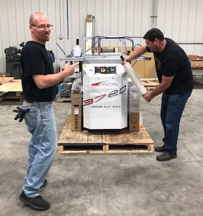 Packing up a Crosscut Power Saw by Chris and Dave. They wrapped the saw in stretch film. The saw is on a skid so it can be shipped to Atlanta for IWF.
