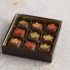 9 pieces of milk chocolate covered caramels with a leaf icing decal in a flat box
