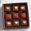 9 caramels with heart icing decals in a box