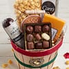 Gift basket filled with sausage, cheese, caramel popcorn, crackers and chocolates