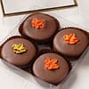4 oreos covered in milk chocolate and topped with a fall leaf icing decal