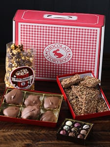 Gingham Classic Chocolate Trunk with pecan turtles, popcorn, truffles and English toffee displayed in open boxes