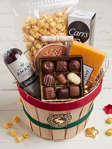 Gift basket filled with sausage, cheese, caramel popcorn, crackers and chocolates