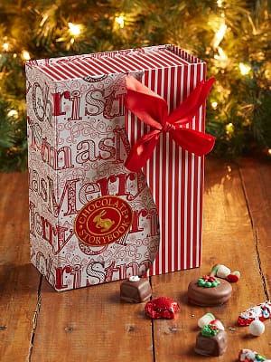 Holiday red and white box with scattered chocolates