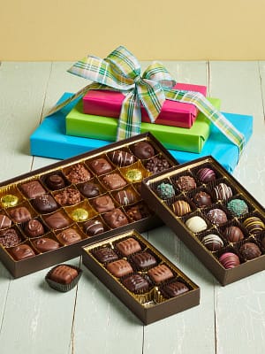 Spring Tower of assorted chocolates and truffle boxes in festive gift wrap.